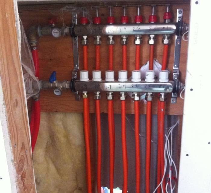 Radiant heating manifold with red PEX loops